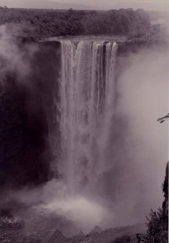 A misty veil attends the thunderous curtain of water. Kaiteur Falls, Guyana